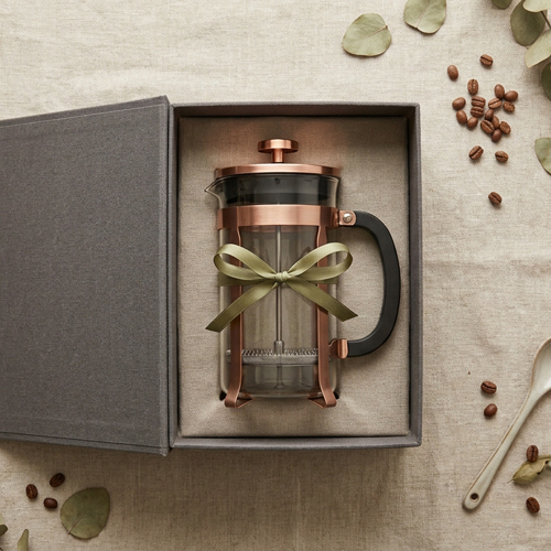 A French Press inside a gift box on a Linen Background