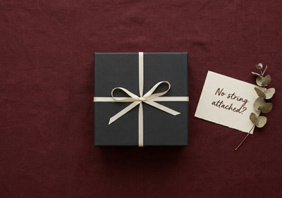 A gift box and a handwritten note on a linen background
