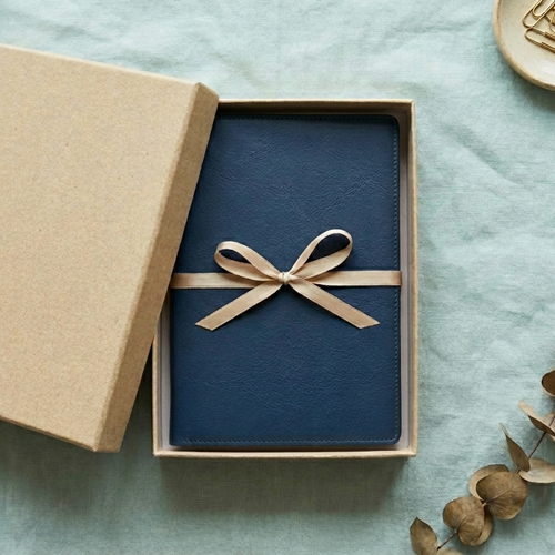 A book inside a gift box on a Linen Background